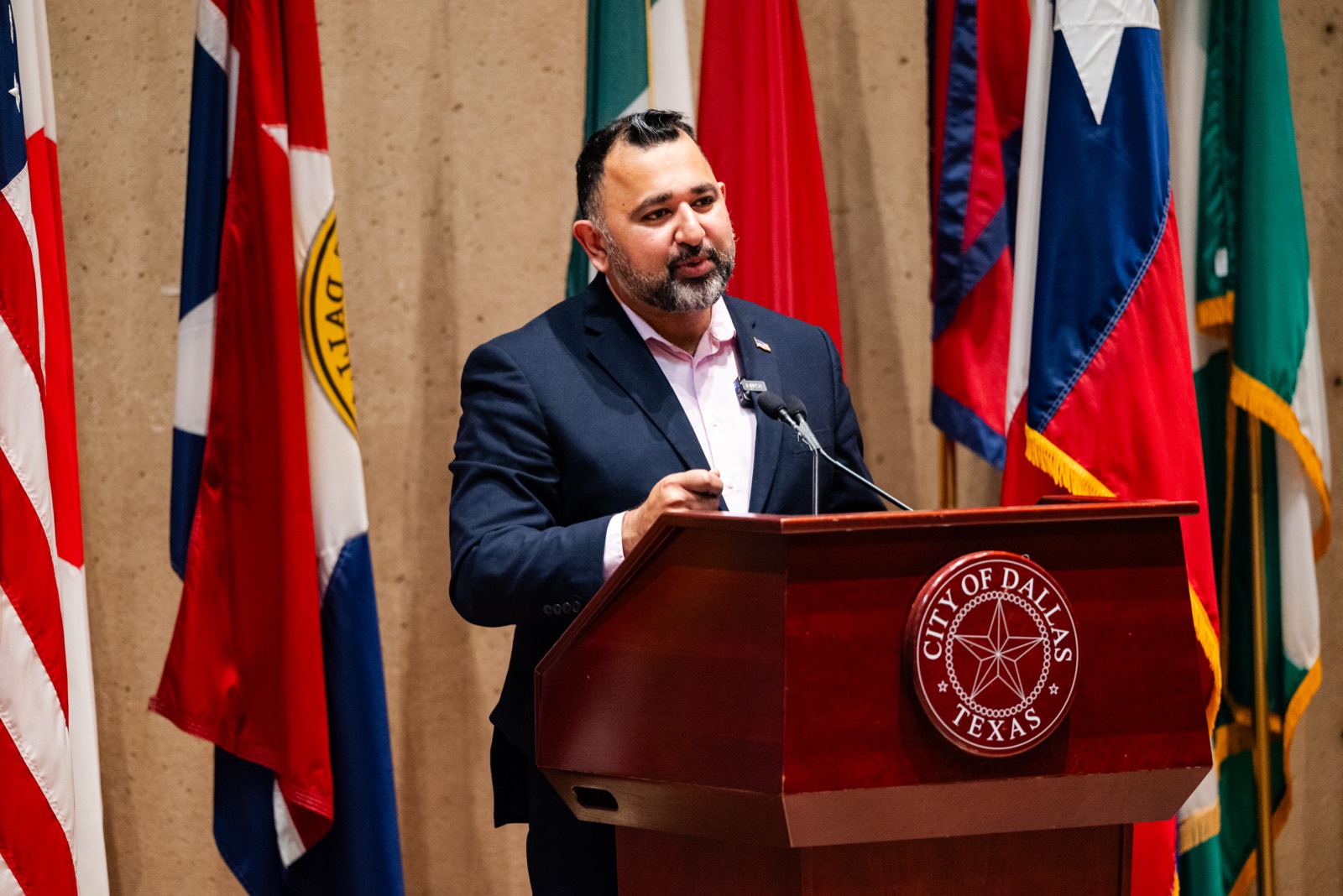 Zeeshan Hafeez speaking at a City of Dallas podium